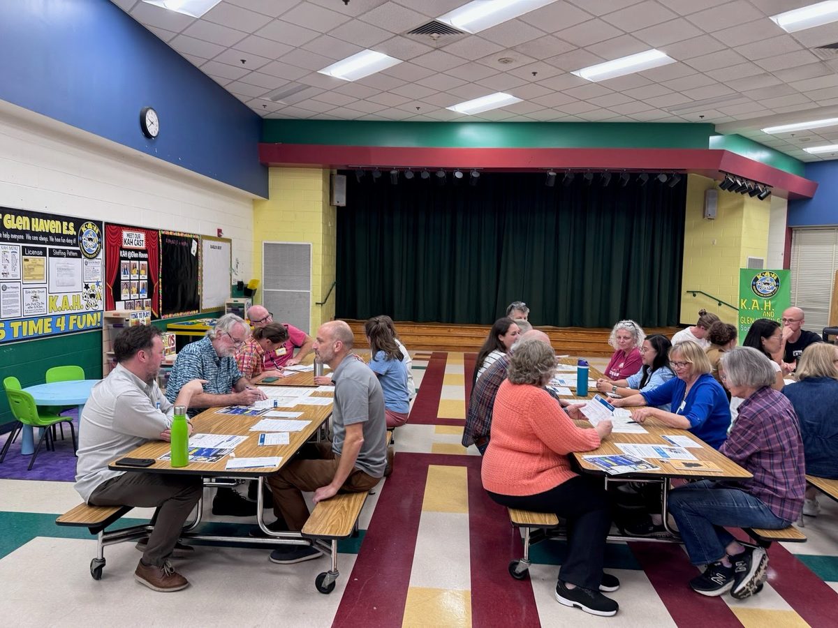 Two tables of neighbors reading handouts and talking with Montgomery Planning staff.